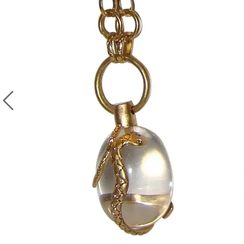 Vintage golden Snake wrapped around an elongated oval crystal